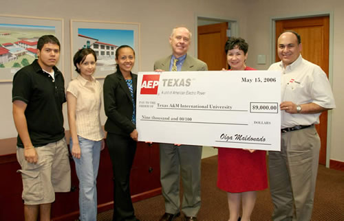 Olga Maldonado from AEP presents a $9,000 donation to TAMIU